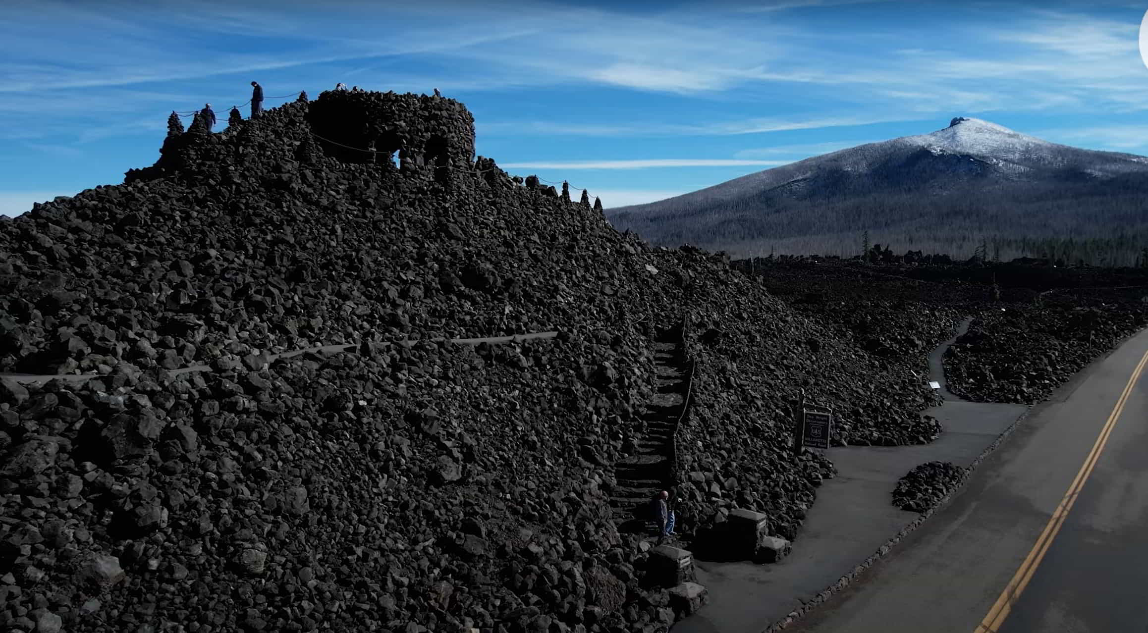 A drone shot of the top of the Mckenzie pass, featuring the Dwight Observatory made of lavarock